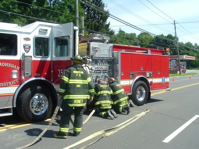 (L to R) Firefighters Honey, Gravius and Capt. Cerrato Packing Up Hose At MVA On Rt. 6